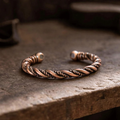 Bronze bracelet on a textured stone surface