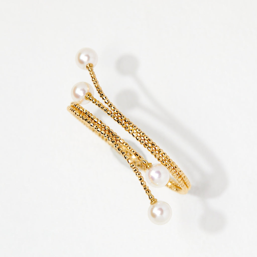 BoxUnboxed 18K yellow gold multi-coil spiral bangle with Akoya pearls and faceted beads.