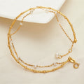 BoxUnboxed dual-layer 18K gold bracelet with freshwater pearls and textured chain. Adjustable length.