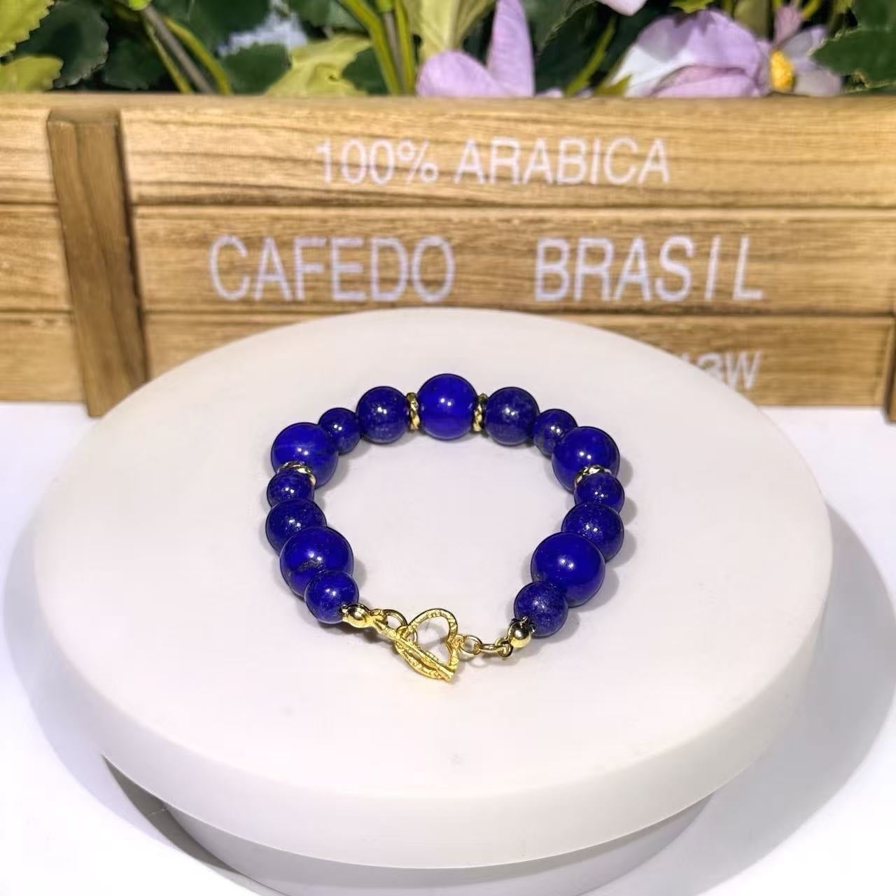 BoxUnboxed Afghan Lapis Lazuli bracelet with deep blue beads, gold-plated spacers, and a gold heart-shaped toggle clasp.