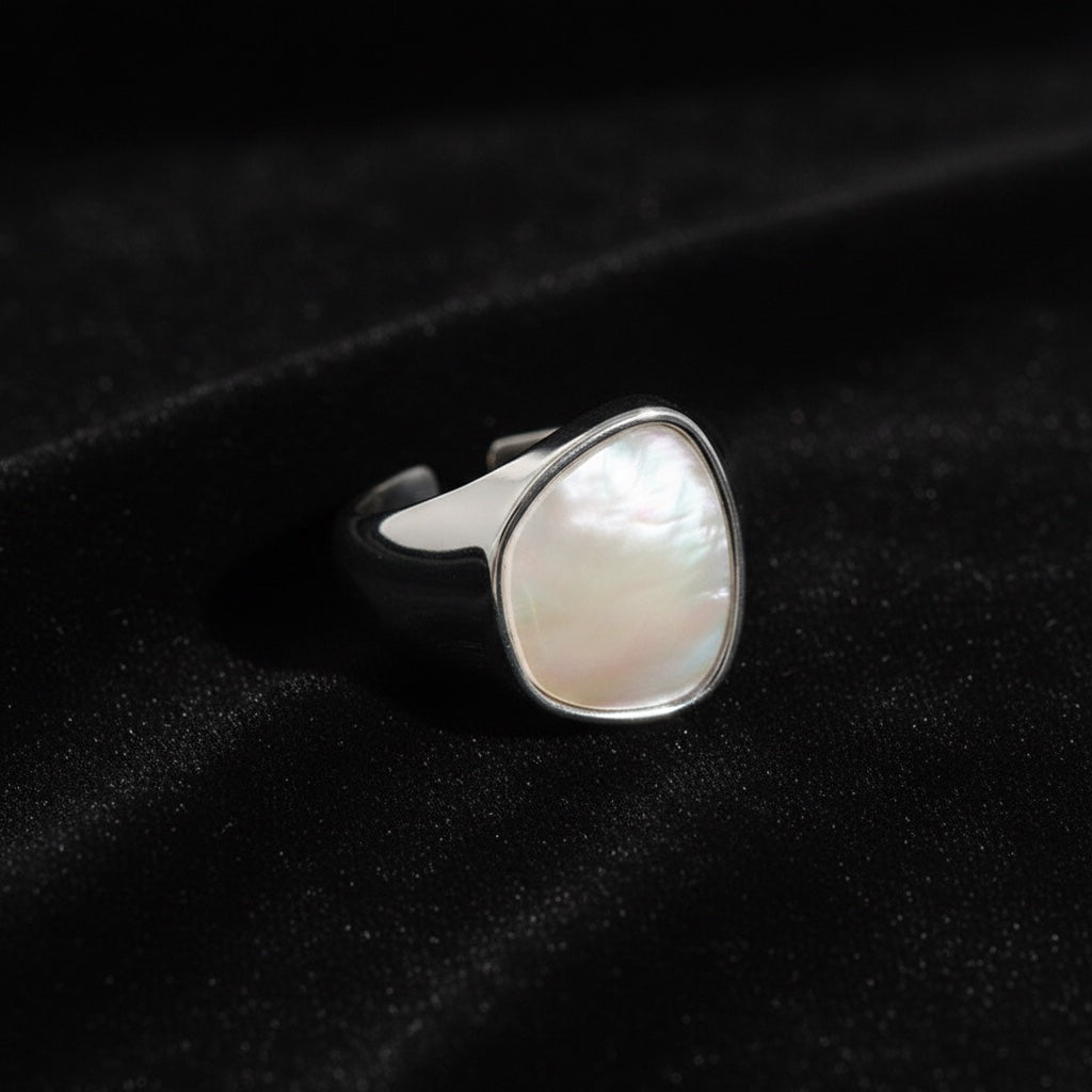 BoxUnboxed Iris ring in sterling silver with a pearlescent inlay. Geometric statement ring with a molten metal silhouette.