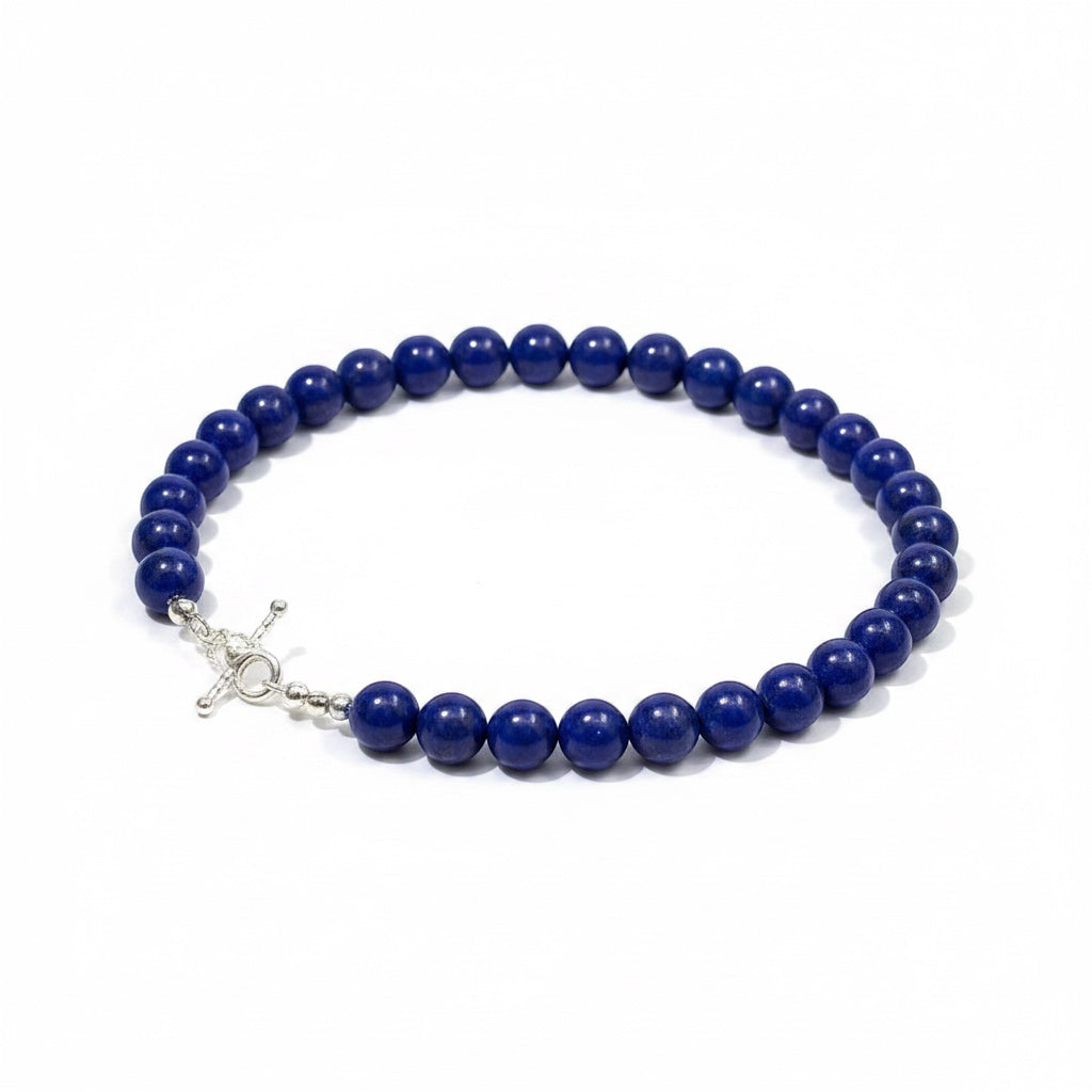 BoxUnboxed natural Afghan lapis lazuli beaded necklace with a silver OT toggle clasp on a white background.