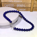 BoxUnboxed natural Afghan Lapis Lazuli beaded necklace with deep royal blue stones and a silver toggle clasp.