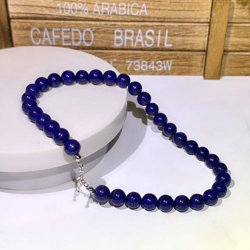 BoxUnboxed natural Afghan Lapis Lazuli beaded necklace with deep royal blue stones and a silver toggle clasp.