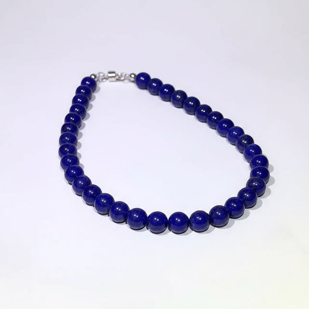 BoxUnboxed natural Afghan Lapis Lazuli beaded necklace with deep blue stones and a silver magnetic clasp.