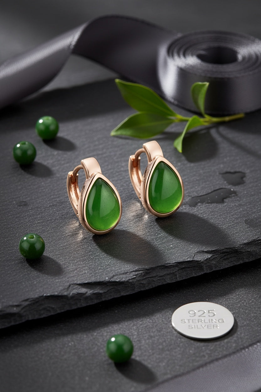 BoxUnboxed rose gold plated huggie earrings featuring natural nephrite jade water droplet stones on a slate background.