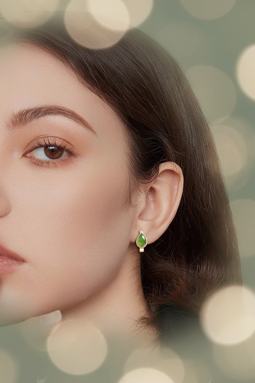 BoxUnboxed rose gold huggie earrings with natural nephrite jade water droplet stones worn by a woman